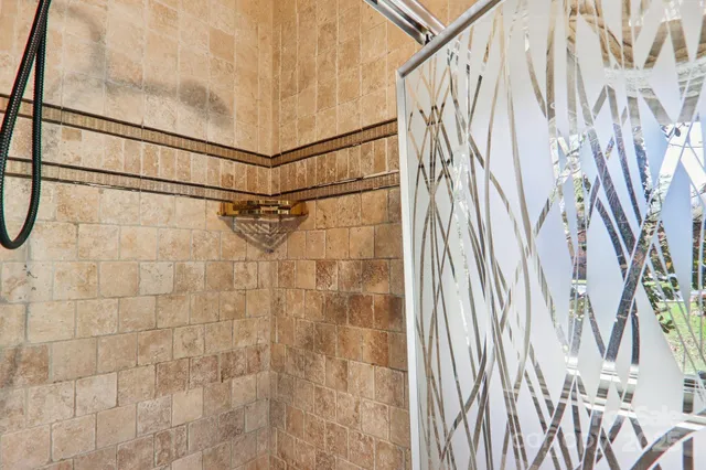 a bathroom with a shower curtain and a shower