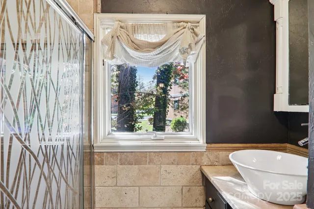 a bathroom with a toilet and a shower curtain