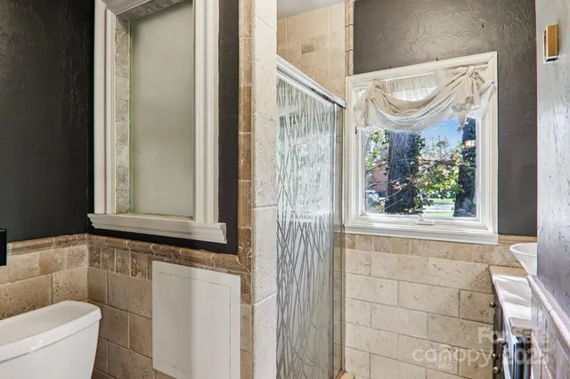 a bathroom with a window and a shower