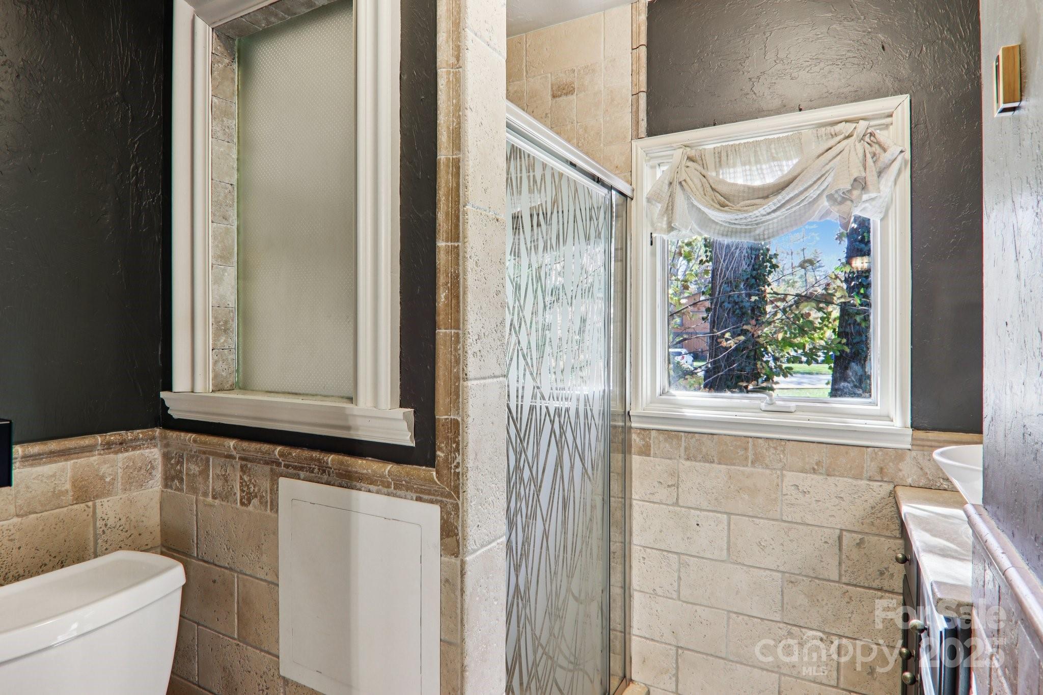 1749 Haywood Road Hendersonville, NC 28791 - Photo 23 of 48 a bathroom with a window and a shower