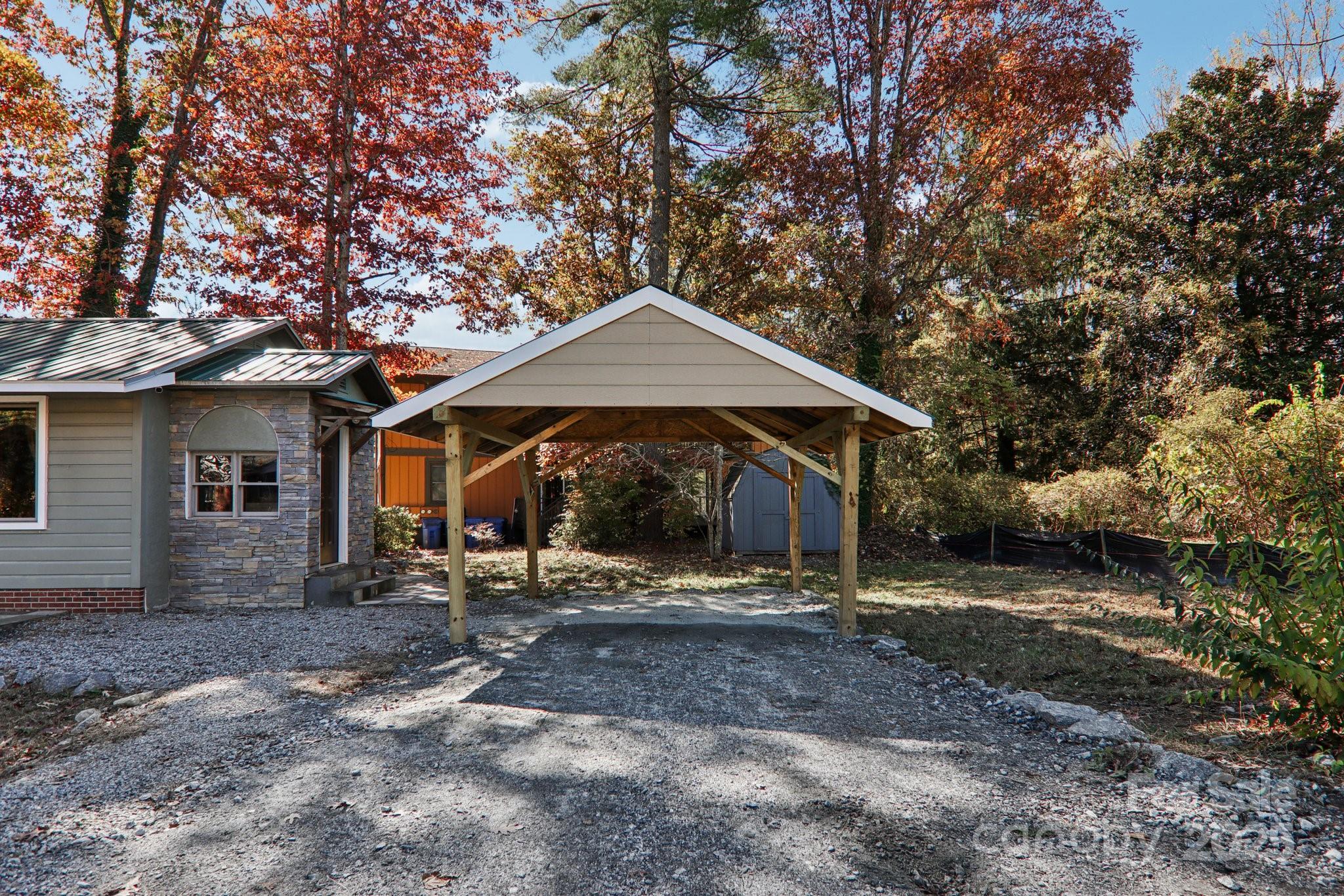 1749 Haywood Road Hendersonville, NC 28791 - Photo 26 of 48 a front view of a house with garden