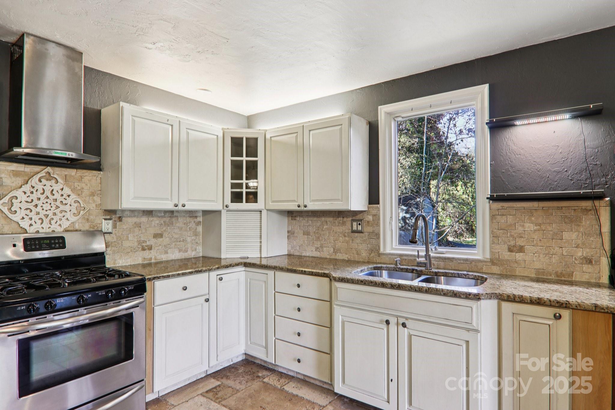1749 Haywood Road Hendersonville, NC 28791 - Photo 3 of 48 a kitchen with granite countertop a sink stainless steel appliances and cabinets
