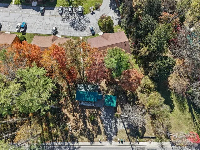 an aerial view of a house with a yard