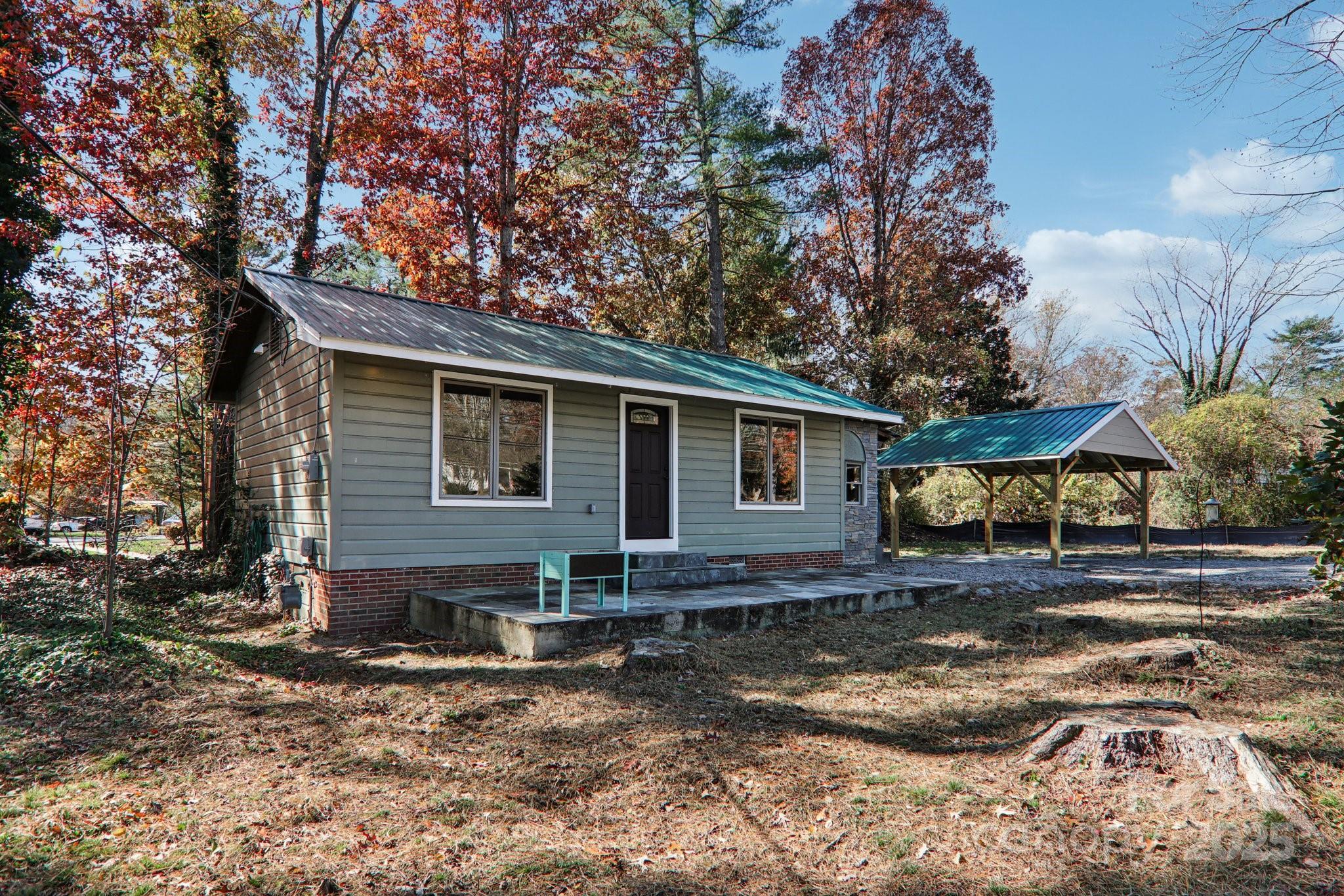 1749 Haywood Road Hendersonville, NC 28791 - Photo 39 of 48 a view of a house with a yard