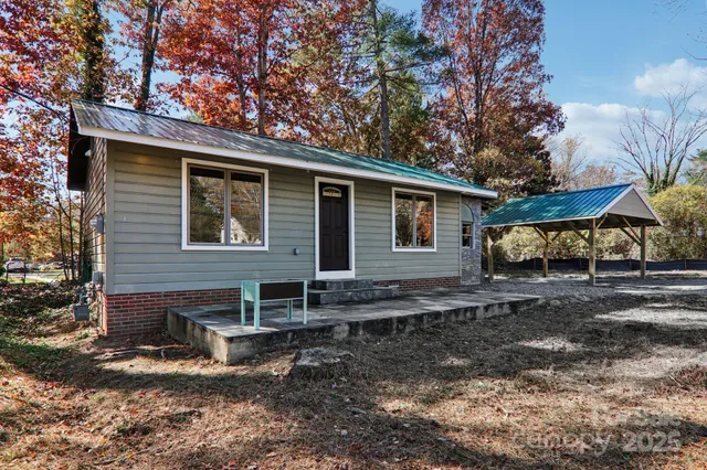 a view of a house with backyard and sitting area