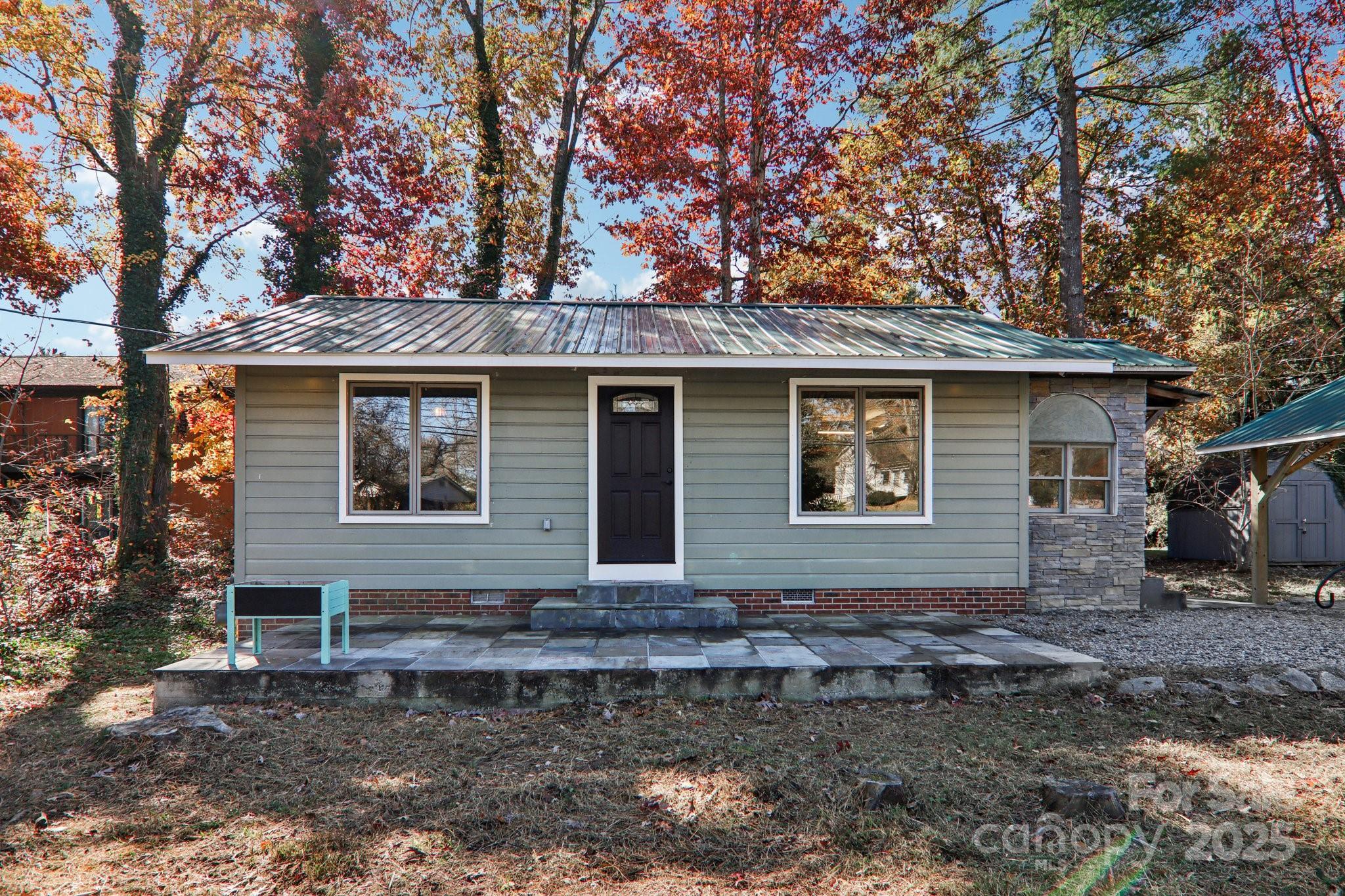 1749 Haywood Road Hendersonville, NC 28791 - Photo 41 of 48 a front view of a house with garden