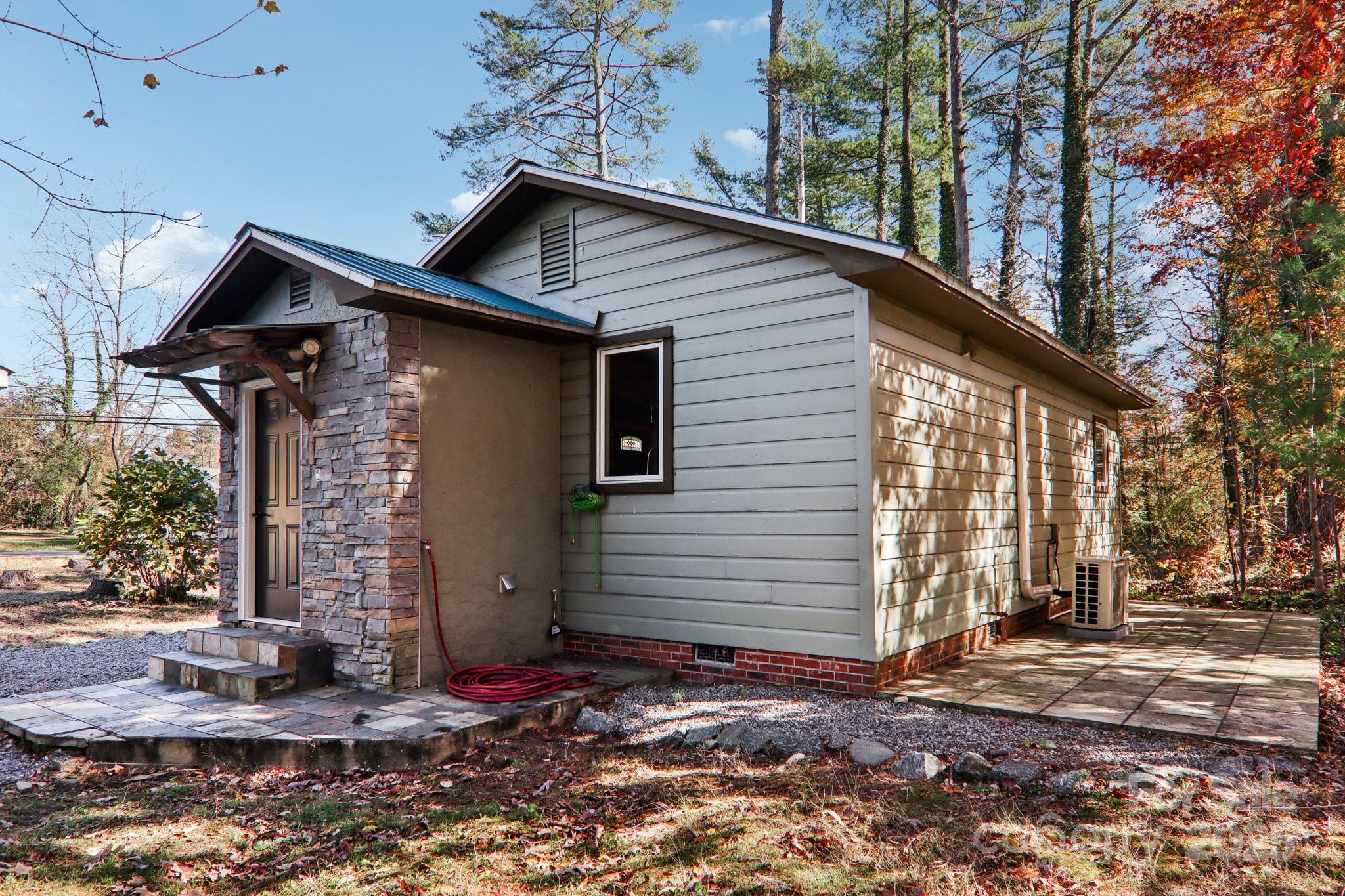 1749 Haywood Road Hendersonville, NC 28791 - Photo 45 of 48 a front view of a house with garden