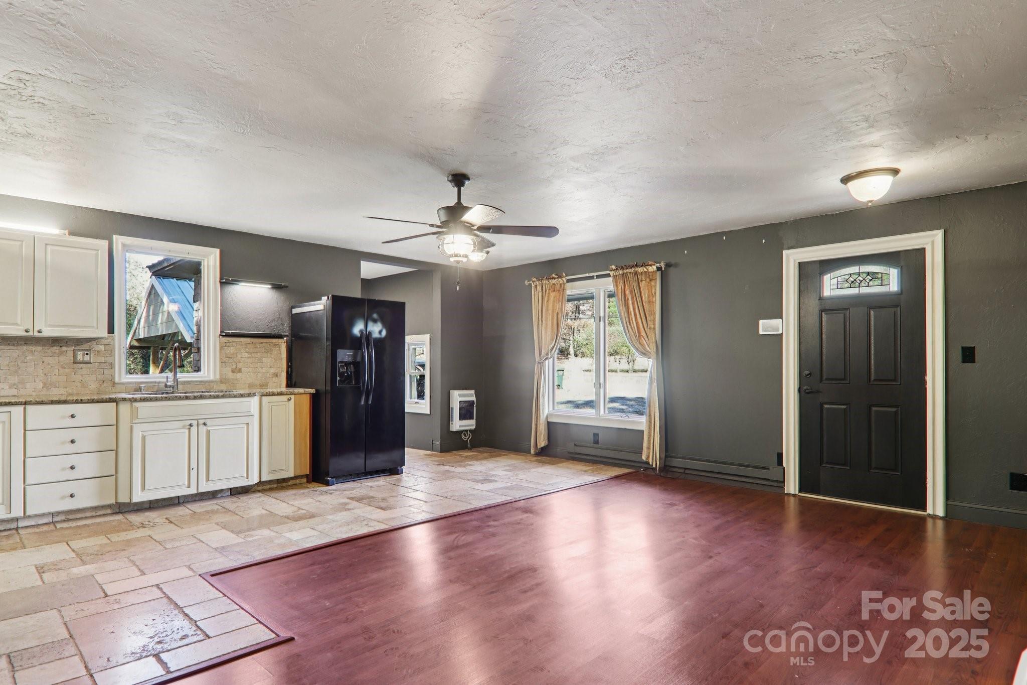 1749 Haywood Road Hendersonville, NC 28791 - Photo 5 of 48 a large kitchen with a wooden floor and chandelier