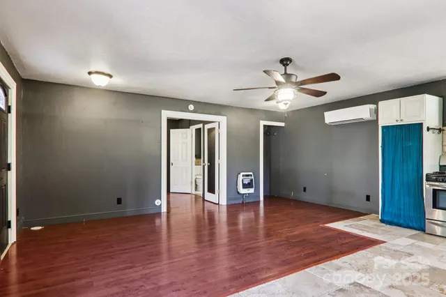 a view of an empty room with wooden floor