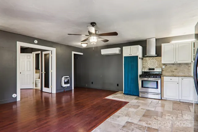 a view of a kitchen with a stove cabinets and wooden floor
