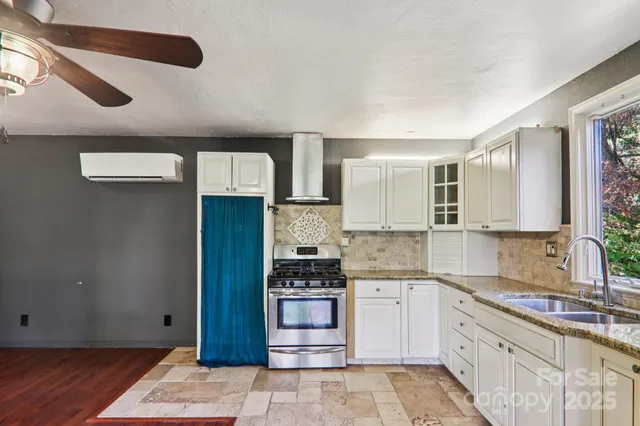 a kitchen with stainless steel appliances granite countertop a refrigerator and a stove
