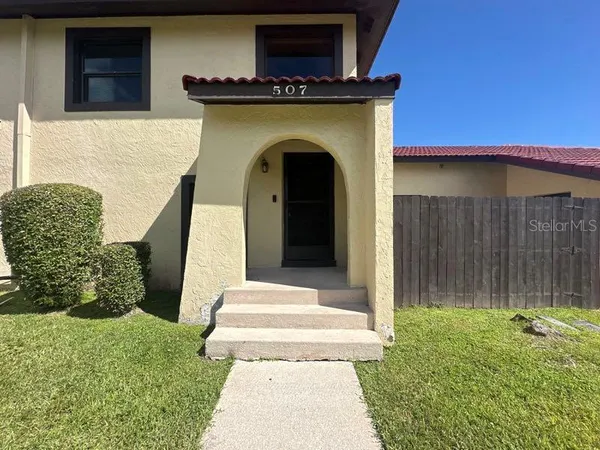 a view of a house with a small yard