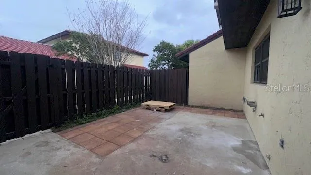 a view of a backyard with wooden fence