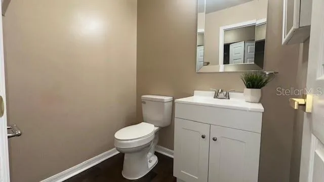 a bathroom with a sink toilet and a mirror