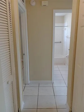 a kitchen with a sink a refrigerator and cabinets