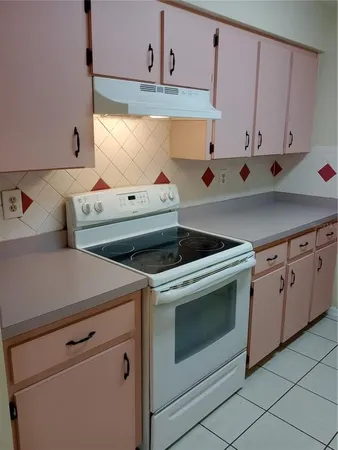 a kitchen with a refrigerator and a sink