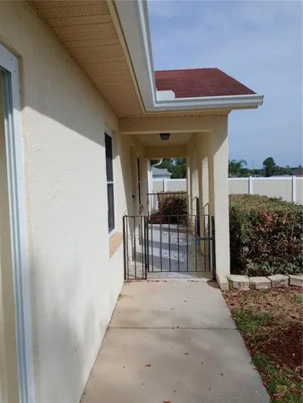 a view of a porch with a table and chairs