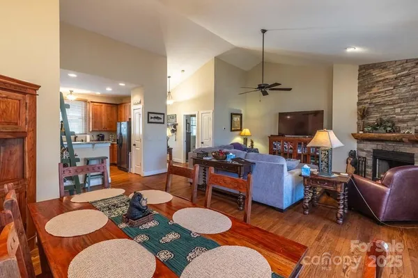 a living room with furniture a fireplace and a chandelier