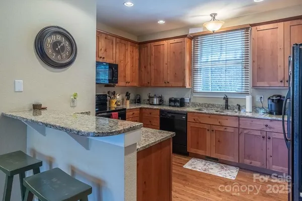 a kitchen with a sink a stove and cabinets