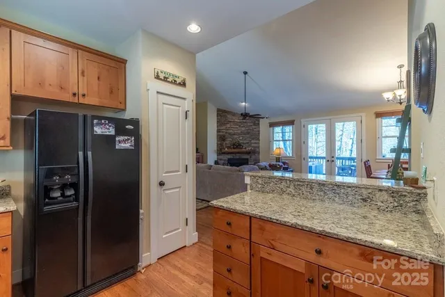 a kitchen with stainless steel appliances granite countertop a refrigerator and a sink