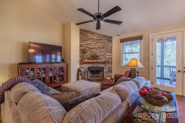 a living room with furniture a fireplace and a flat screen tv