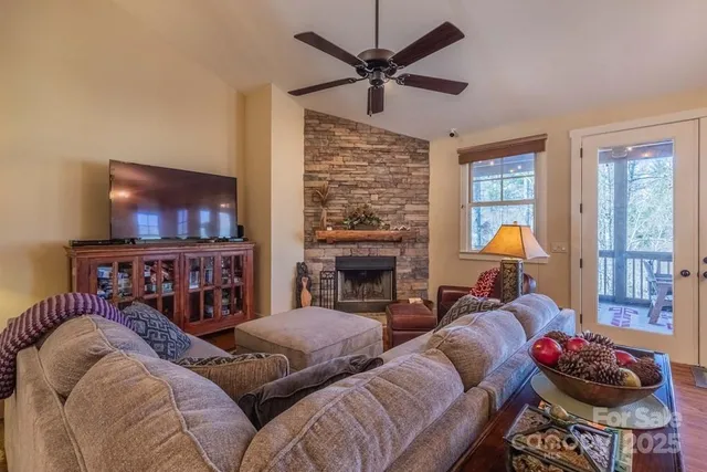 a living room with furniture a fireplace and a flat screen tv