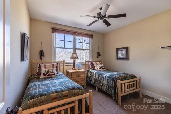 a bedroom with two beds and a window