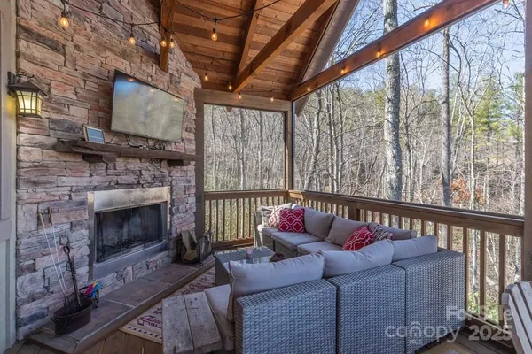 a living room with furniture a fireplace with a flat screen tv