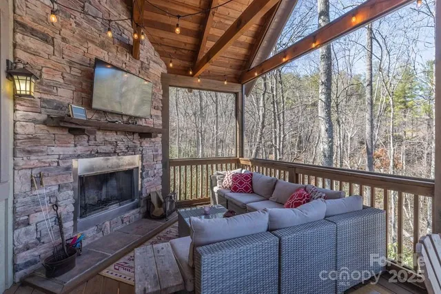 a living room with furniture a fireplace with a flat screen tv