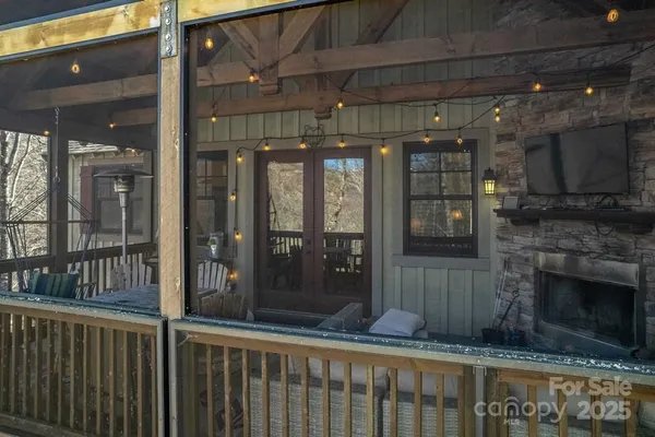 a porch with a table and chairs