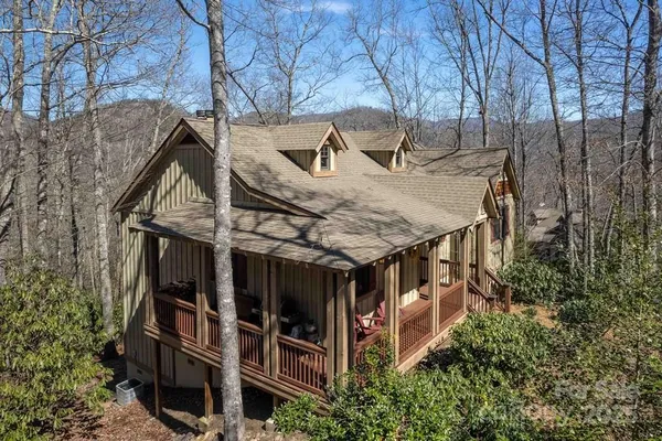 a view of a house with roof deck and sitting area