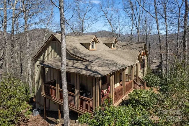 a view of a house with roof deck and sitting area