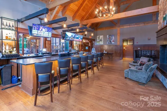 a living room with furniture a fireplace and wooden floor