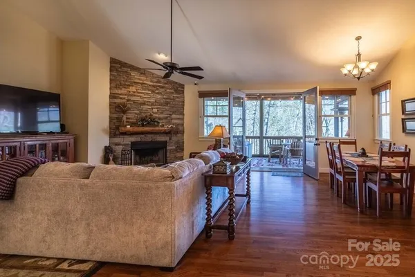 a living room with furniture a fireplace and a flat screen tv