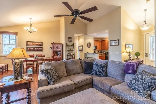 a living room with furniture a lamp and a chandelier
