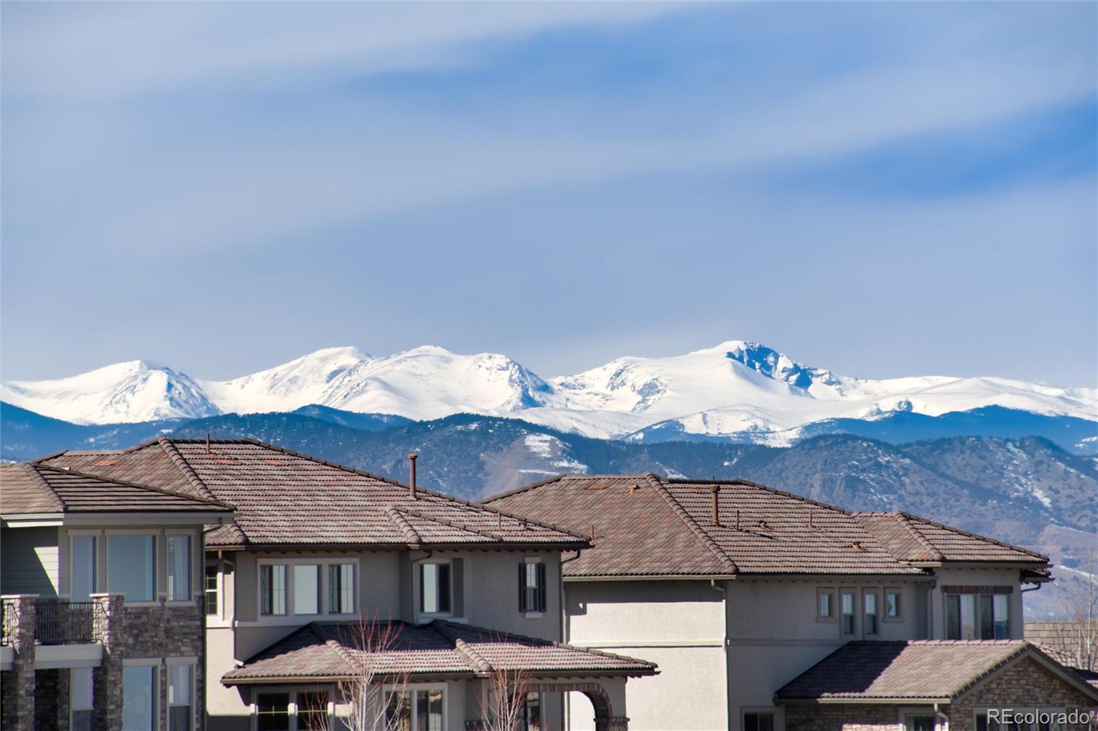 10841 Greycliffe Drive Highlands Ranch, CO 80126 - Photo 5 of 25 a front view of a house with a yard and mountain view