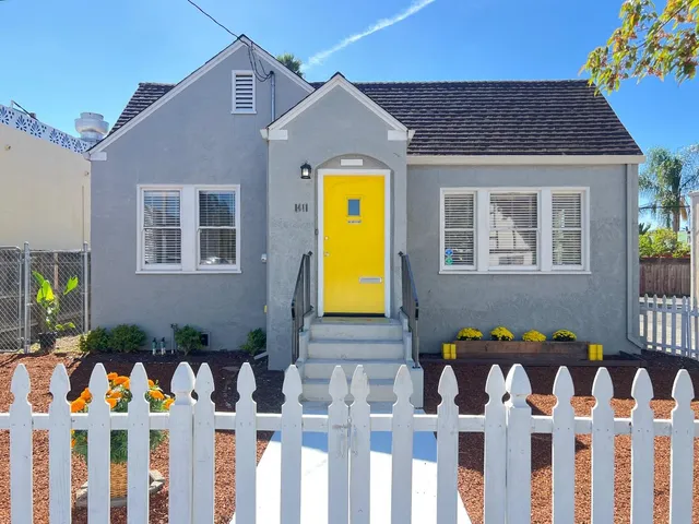 a front view of house with front door and wooden fence