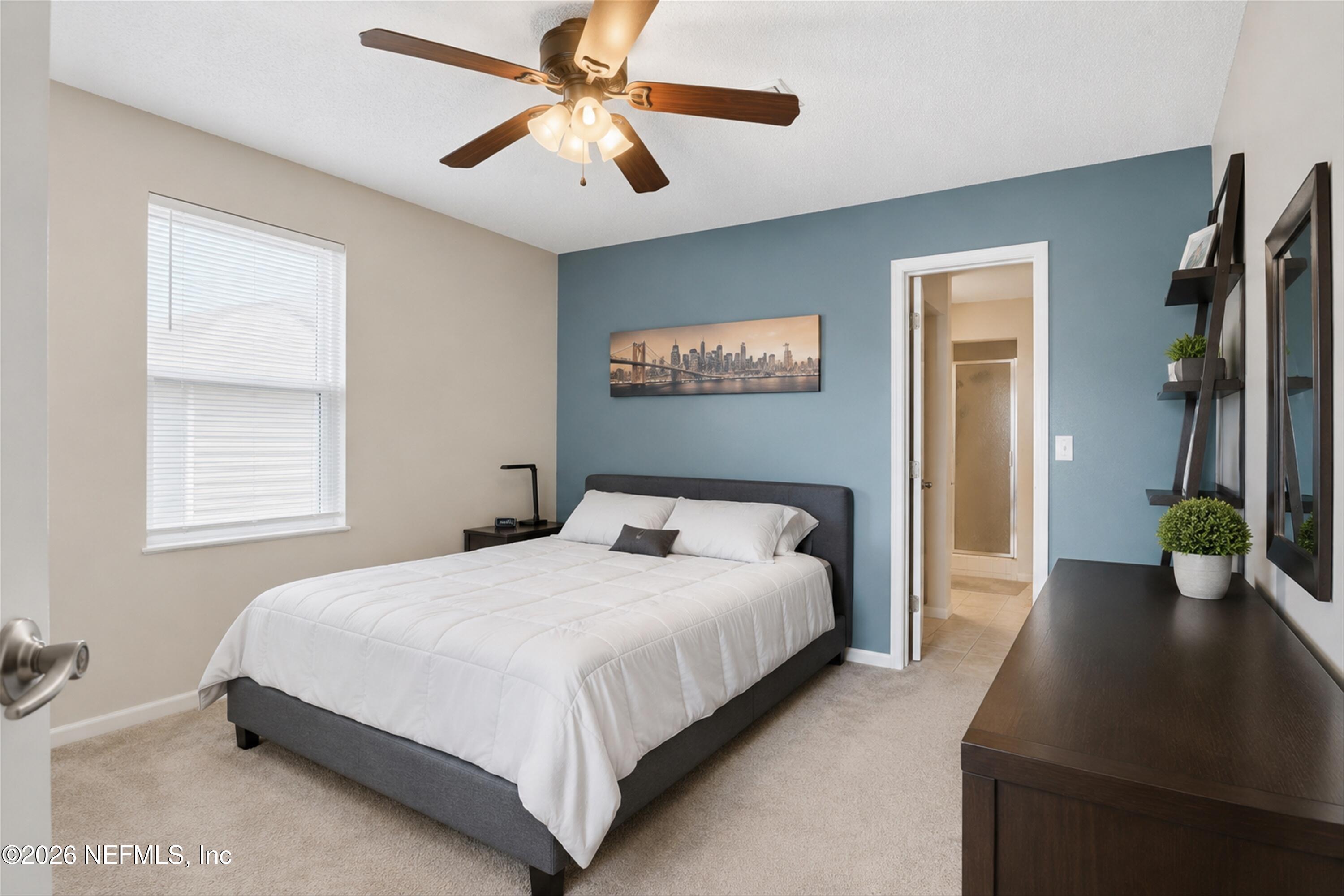 124 Hopkins Street Neptune Beach, FL 32266 - Photo 11 of 44 a bedroom with a bed and a chandelier