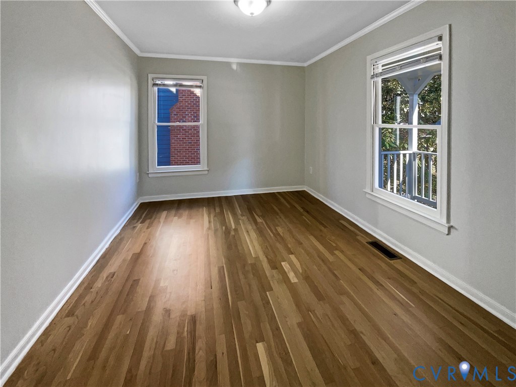 5614 Chatmoss Road Midlothian, VA 23112 - Photo 14 of 25 a view of an empty room with wooden floor and windows