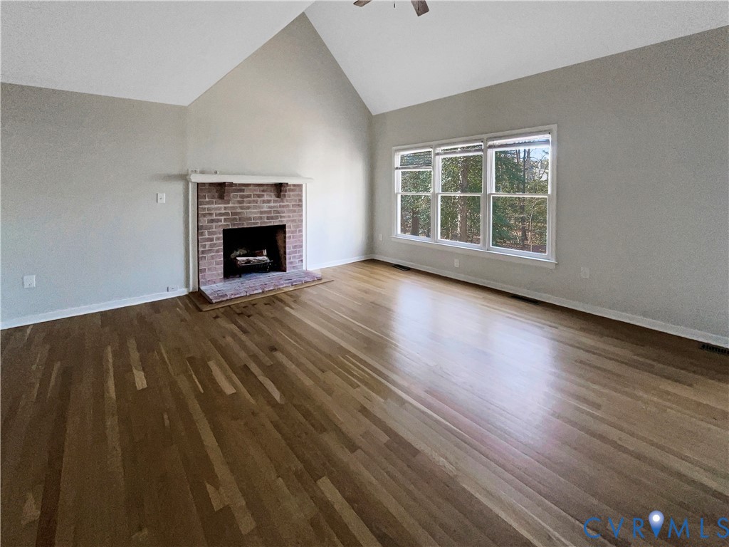 5614 Chatmoss Road Midlothian, VA 23112 - Photo 3 of 25 a view of an empty room with wooden floor fireplace and a window