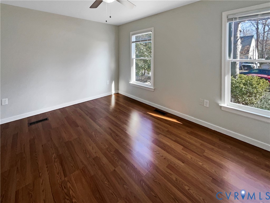 5614 Chatmoss Road Midlothian, VA 23112 - Photo 5 of 25 a view of an empty room with wooden floor and a window