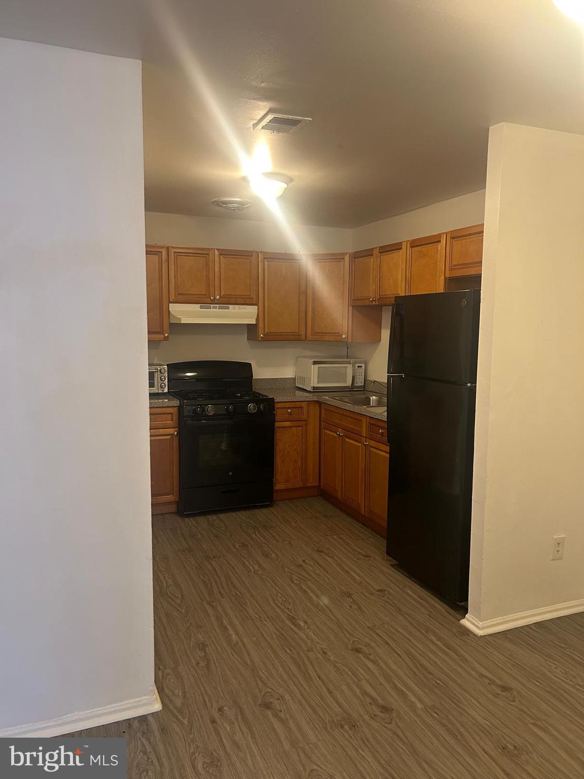 9455 Fairgreen Lane Philadelphia, PA 19114 - Photo 3 of 10 a kitchen with granite countertop a refrigerator and a sink