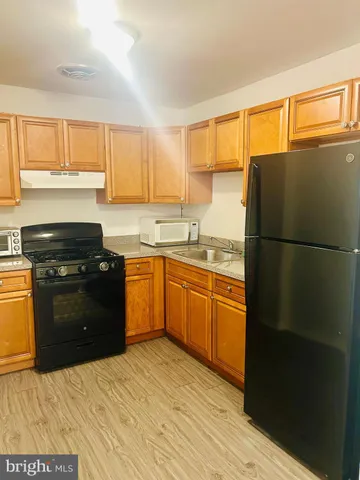 a kitchen with a refrigerator stove and sink
