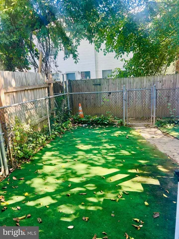 a garden with trees in front of it