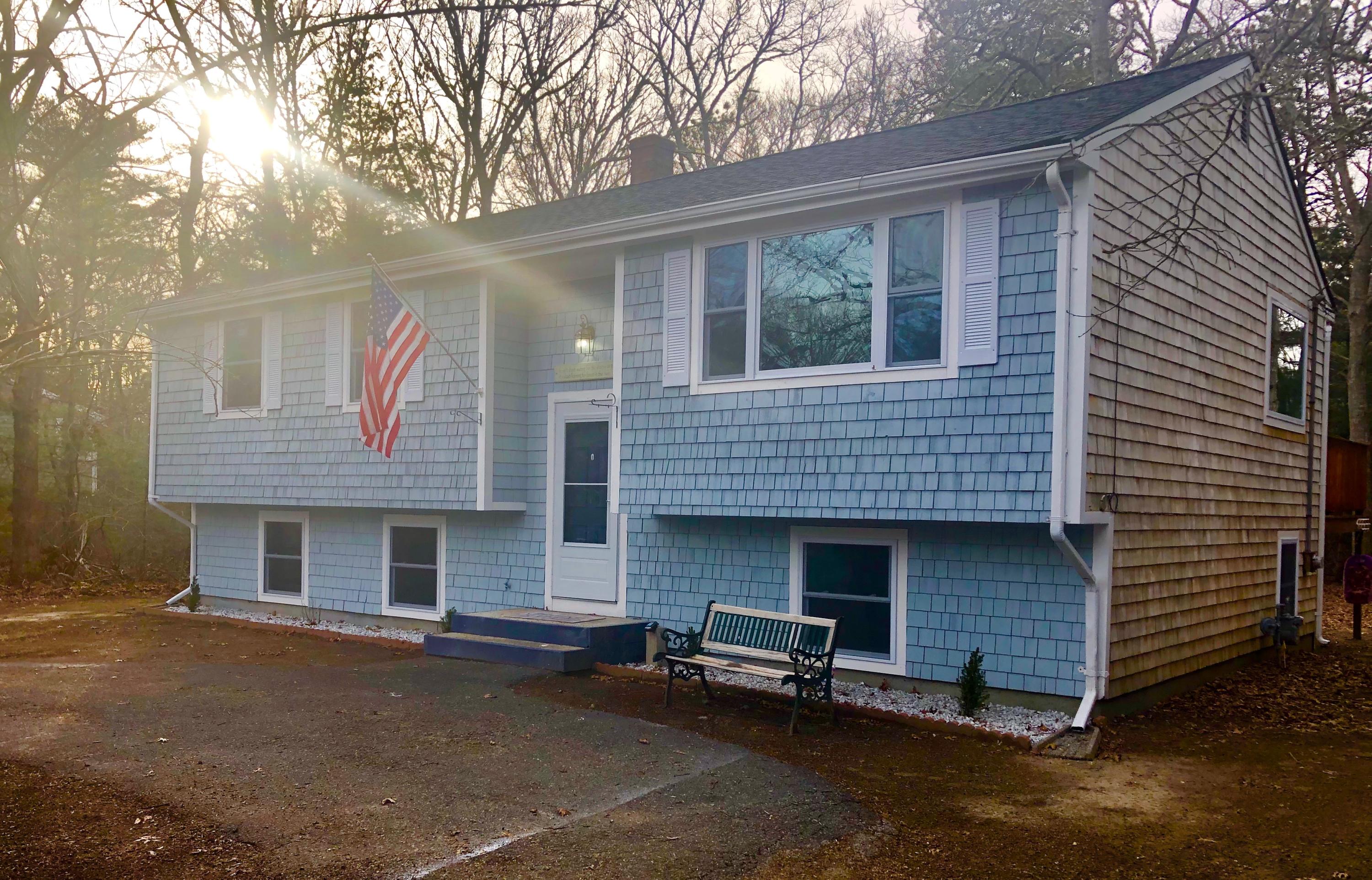 57 Stage Coach Road Centerville, MA 02632 - Photo 2 of 34 a front view of a house with a garage