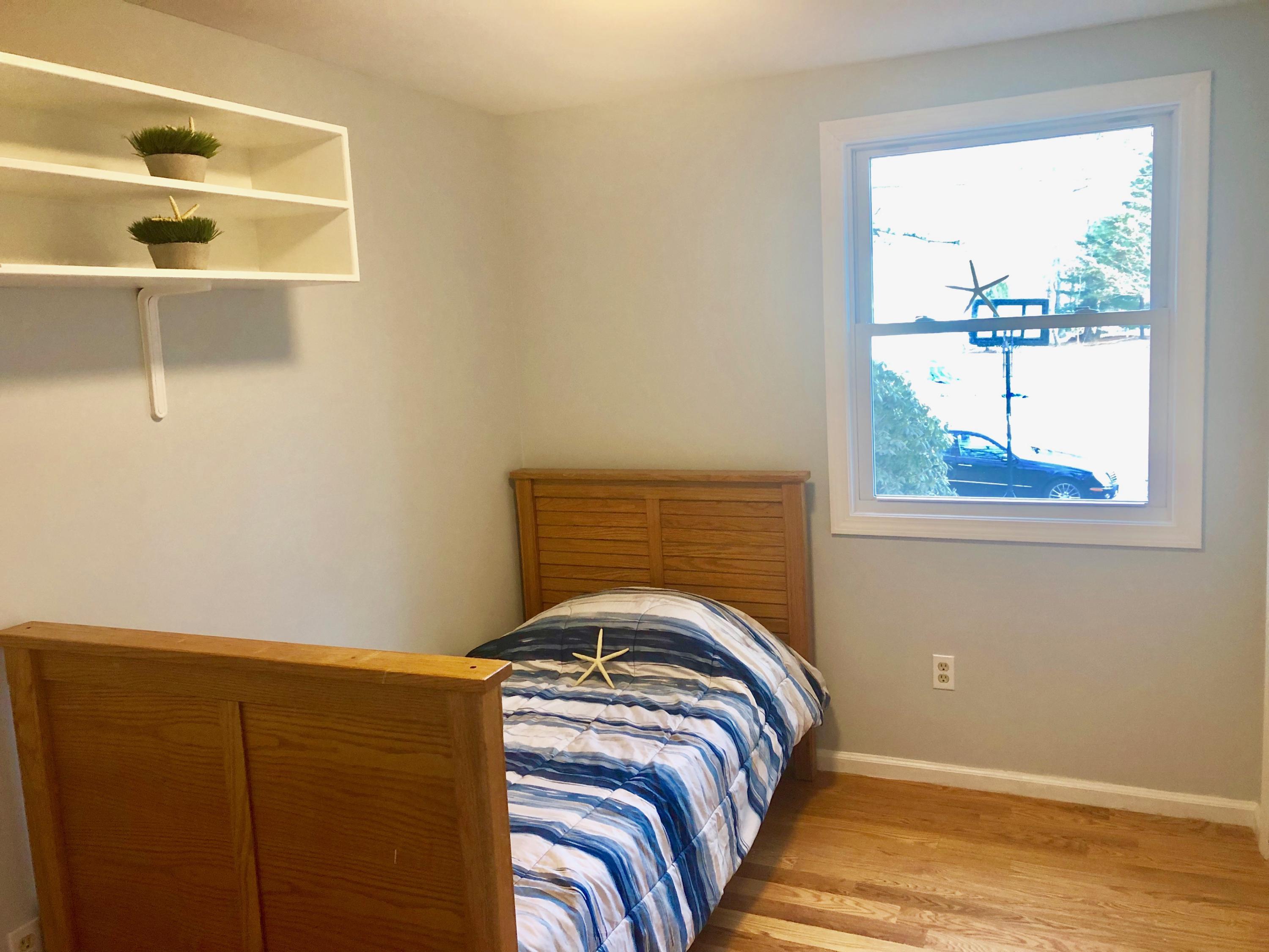 57 Stage Coach Road Centerville, MA 02632 - Photo 28 of 34 a view of a bedroom with wooden floor and window
