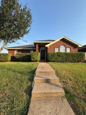 a front view of a house with yard