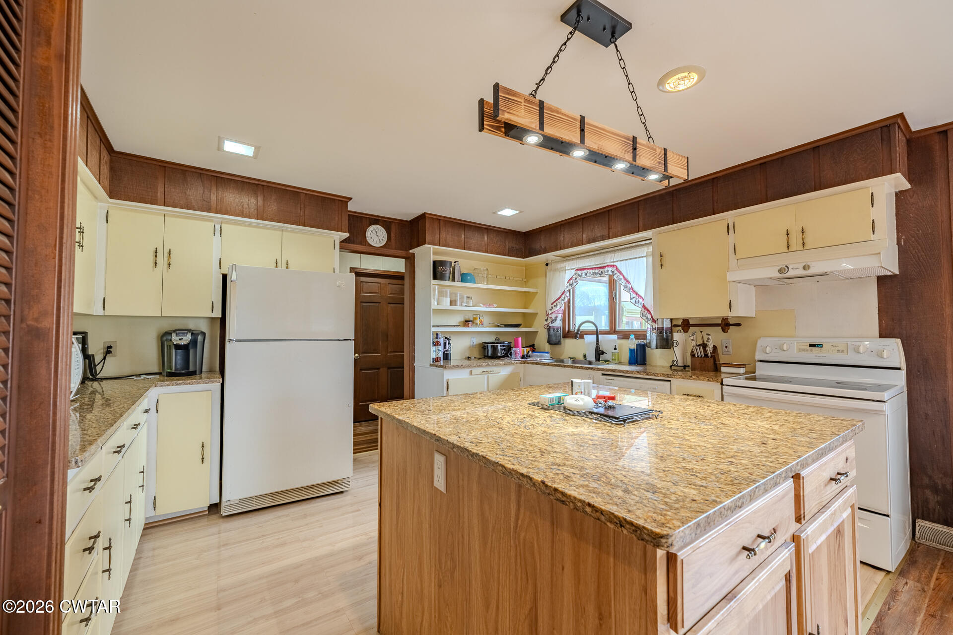 428 Gwin Cemetery Road Waverly, TN 37185 - Photo 14 of 50 a kitchen with stainless steel appliances granite countertop a refrigerator a sink dishwasher a stove and white cabinets with wooden floor