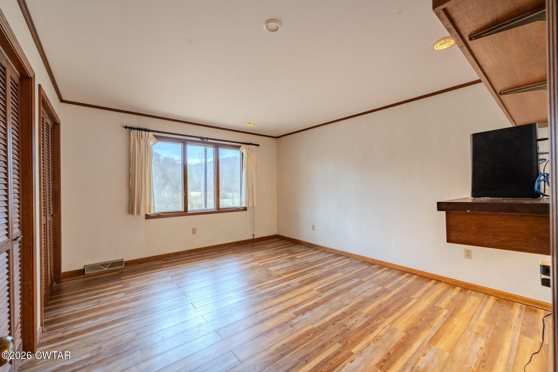 428 Gwin Cemetery Road Waverly, TN 37185 - Photo 21 of 50 a view of a livingroom with wooden floor and a flat screen tv