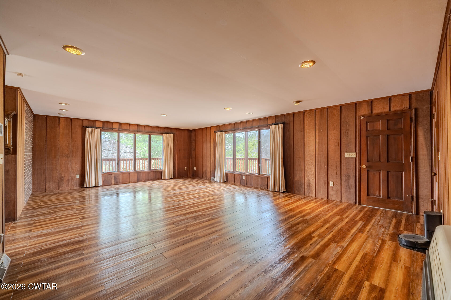 428 Gwin Cemetery Road Waverly, TN 37185 - Photo 9 of 50 a view of an empty room with wooden floor and a window
